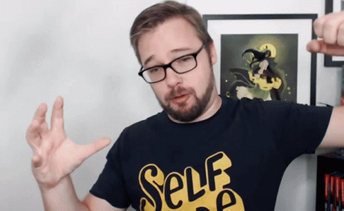 A Man Wearing Glasses And A Black Shirt That Says Self GIF
