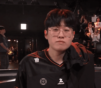 A Man Wearing Glasses And A Black Shirt That Says ' Z ' On It GIF