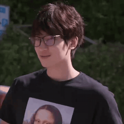 A Man Wearing Glasses And A Black Shirt With A Picture Of Mona Lisa GIF