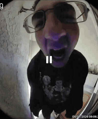 A Man Wearing Glasses And A Black Shirt With A Skull On It GIF