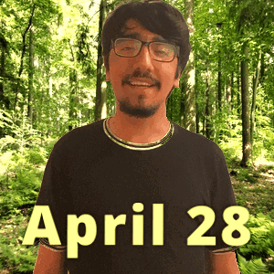A Man Wearing Glasses And A Black Shirt With April 28 Written On It GIF