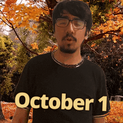 A Man Wearing Glasses And A Black Shirt With October 1 Written On It GIF