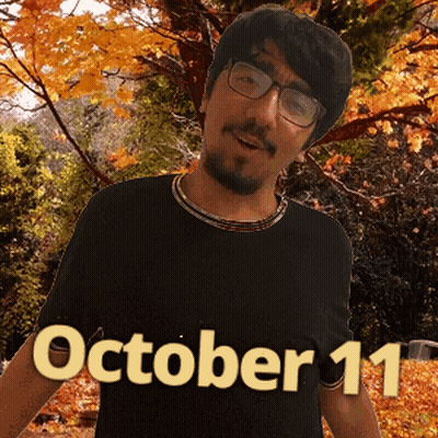A Man Wearing Glasses And A Black Shirt With October 11 On It GIF