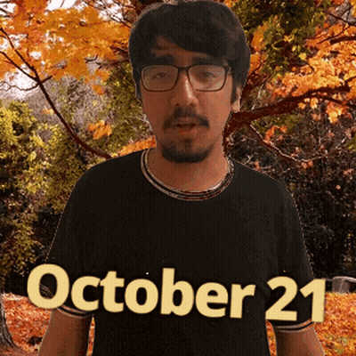 A Man Wearing Glasses And A Black Shirt With The Date Of October 21 GIF