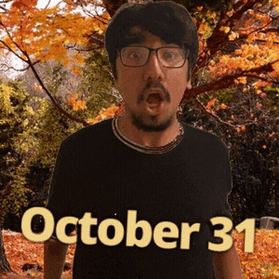 A Man Wearing Glasses And A Black Shirt With The Date Of October 31 On It GIF