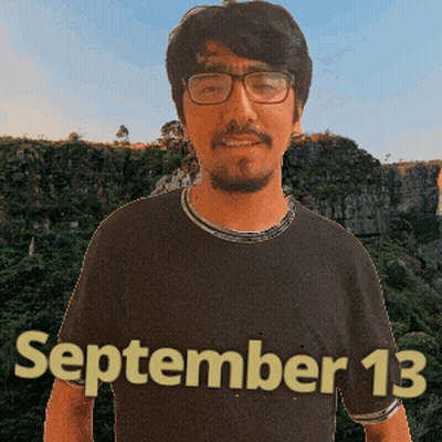 A Man Wearing Glasses And A Black Shirt With The Date September 13 On It GIF