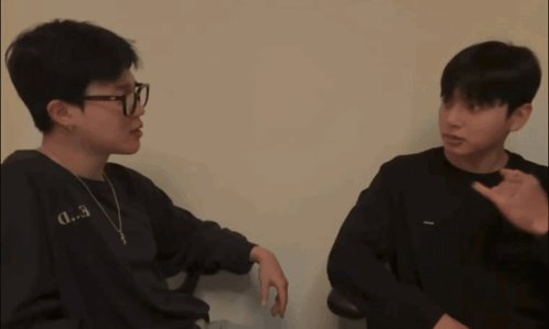 A Man Wearing Glasses And A Black Shirt With The Letter D.3 On It GIF