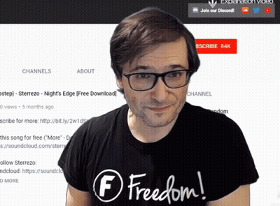 a man wearing glasses and a black shirt with the word freedom on it