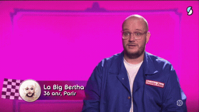 A Man Wearing Glasses And A Blue Jacket Says La Big Bertha GIF