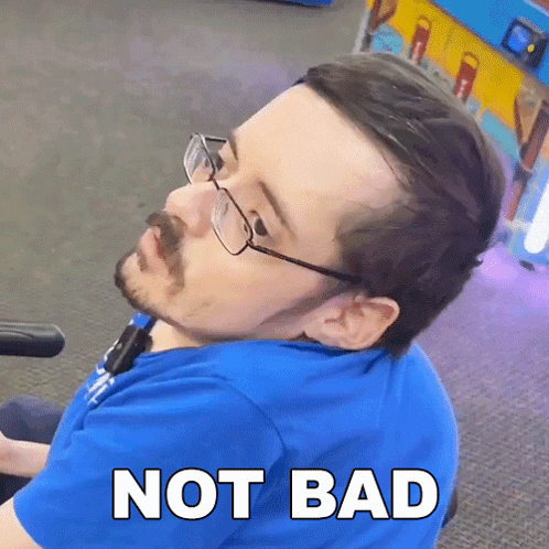 A Man Wearing Glasses And A Blue Shirt Has The Word Not Bad Written On His Face GIF