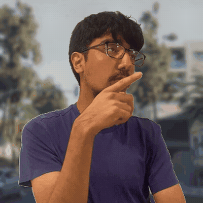 A Man Wearing Glasses And A Blue Shirt Holds His Finger To His Chin GIF