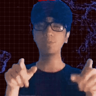 A Man Wearing Glasses And A Blue Shirt Is Pointing GIF