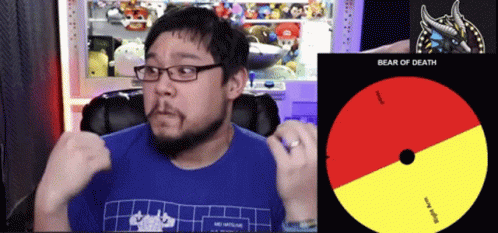A Man Wearing Glasses And A Blue Shirt Is Sitting In Front Of A Cd That Says Bear Of Death GIF