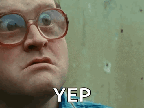 A Man Wearing Glasses And A Blue Shirt Says Yep On His Face GIF