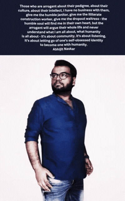 A Man Wearing Glasses And A Blue Shirt Stands In Front Of A Quote By Aishwarjit Naskar GIF