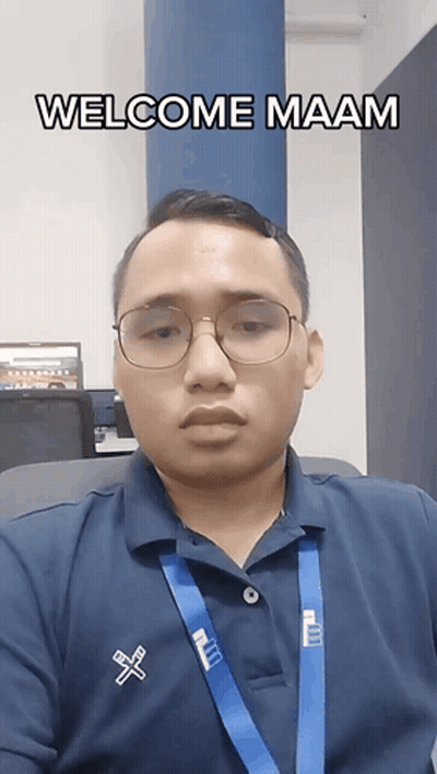 A Man Wearing Glasses And A Blue Shirt That Says Welcome Maam On It GIF