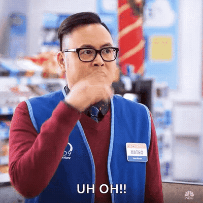 A Man Wearing Glasses And A Blue Vest Is Making A Funny Face And Saying Uh Oh ! GIF