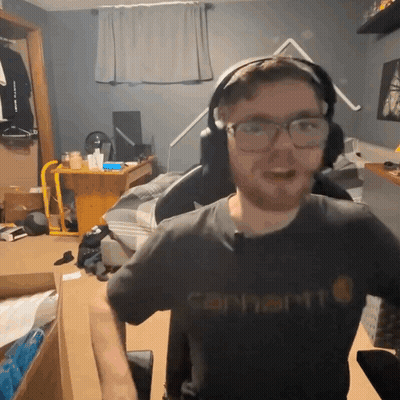 A Man Wearing Glasses And A Carhartt Shirt GIF