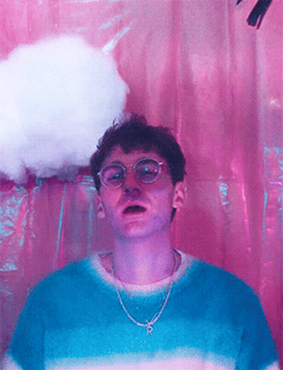 A Man Wearing Glasses And A Chain With The Letter P On It GIF