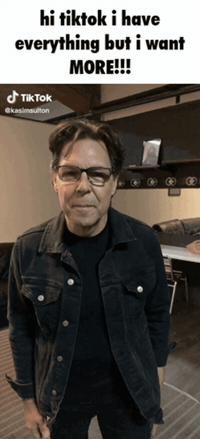 A Man Wearing Glasses And A Denim Jacket Says Hi Tiktok I Have Everything But I Want More .. GIF
