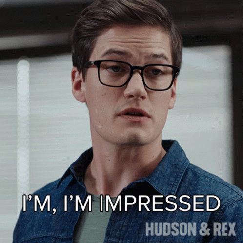 A Man Wearing Glasses And A Denim Shirt Says I 'M Impressed GIF