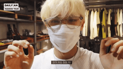 A Man Wearing Glasses And A Face Mask With Daily An Fashion Tour On The Bottom GIF