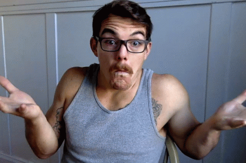 A Man Wearing Glasses And A Gray Tank Top Makes A Funny Face GIF