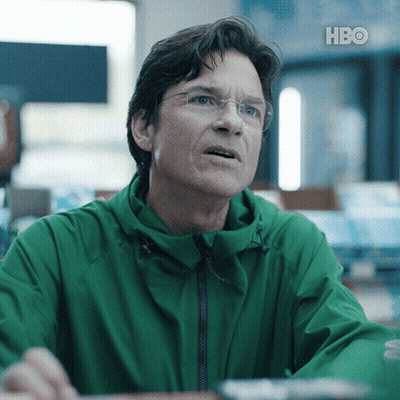 A Man Wearing Glasses And A Green Jacket With Hbo Written On The Bottom Right GIF