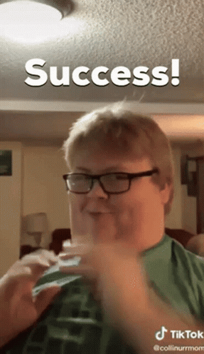 A Man Wearing Glasses And A Green Shirt Is Making A Funny Face And The Caption Says Success GIF