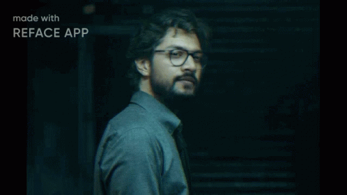 A Man Wearing Glasses And A Grey Shirt Is Made With Reface App GIF