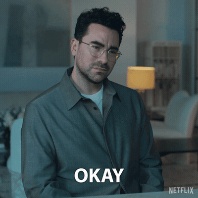 A Man Wearing Glasses And A Grey Shirt Says Okay GIF