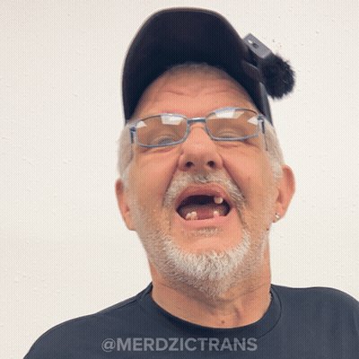 A Man Wearing Glasses And A Hat Has The Word Merdzictrans On The Bottom GIF