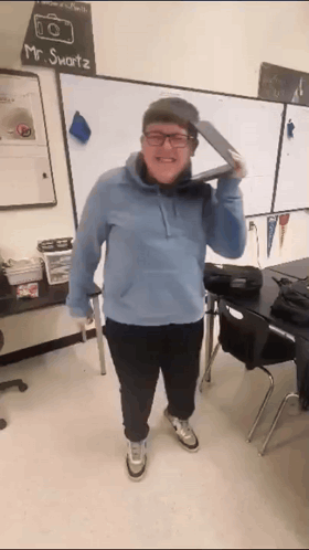 A Man Wearing Glasses And A Hat Is Standing In Front Of A White Board That Says Mr. Smartz GIF