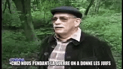 A Man Wearing Glasses And A Hat Is Standing In The Woods And Says Chez Nous GIF