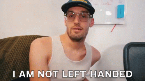 A Man Wearing Glasses And A Hat Says I Am Not Left Handed GIF