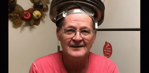 A Man Wearing Glasses And A Hat With A Red Sticker That Says Red Collar Society On It . GIF