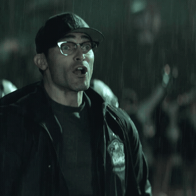 A Man Wearing Glasses And A Hat With The Letter B On It Is Making A Funny Face GIF