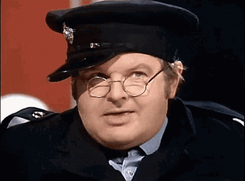 A Man Wearing Glasses And A Hat With The Letter U On It GIF