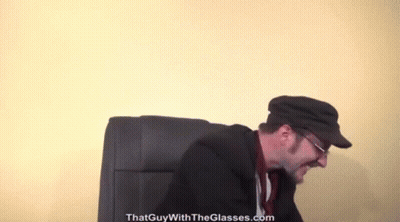 A Man Wearing Glasses And A Hat With The Website Thatguywiththeglasses.com In The Corner GIF