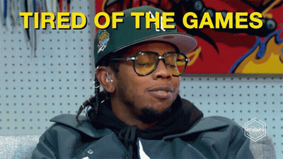A Man Wearing Glasses And A Hat With The Words Tired Of The Games Above Him GIF