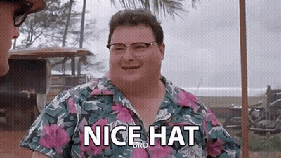 A Man Wearing Glasses And A Hawaiian Shirt Is Smiling And Saying `` Nice Hat `` . GIF