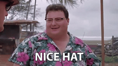 A Man Wearing Glasses And A Hawaiian Shirt Is Standing Next To Another Man And Saying `` Nice Hat '' . GIF