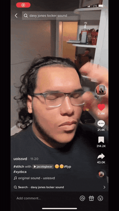 A Man Wearing Glasses And A Headband Is On A Tiktok Video GIF