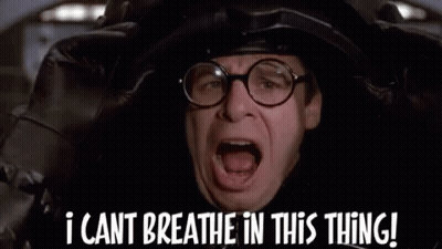 A Man Wearing Glasses And A Helmet Is Saying `` I Cant Breathe In This Thing ! '' GIF