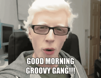 A Man Wearing Glasses And A Hoodie Says Good Morning Groovy Gang GIF