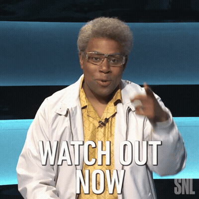 A Man Wearing Glasses And A Jacket Says Watch Out Now GIF