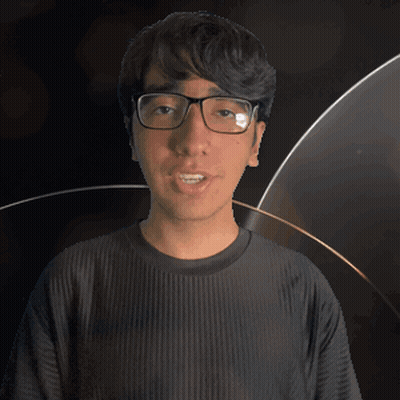 A Man Wearing Glasses And A Kane Shirt Looks At The Camera GIF