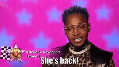 A Man Wearing Glasses And A Leopard Print Shirt Says She 'S Back GIF