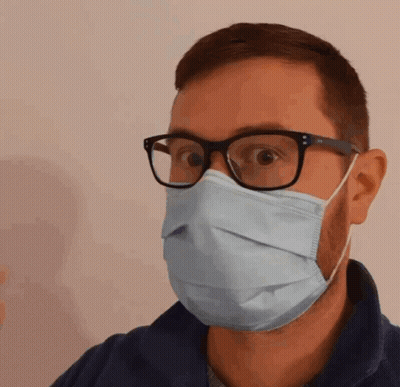 A Man Wearing Glasses And A Medical Mask GIF