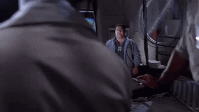 A Man Wearing Glasses And A Name Tag That Says ' Smith ' On It Is Making A Funny Face . GIF